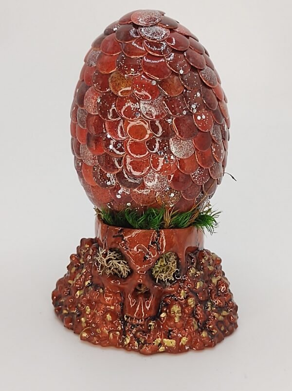 Handcrafted dragon egg in crimson red with skull stand
